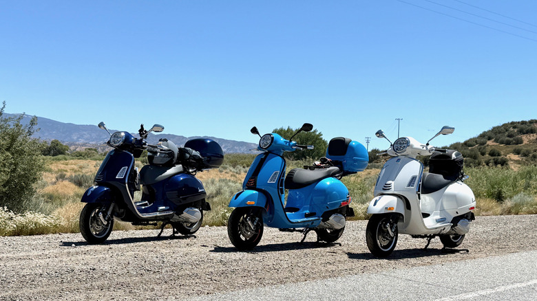 A group of Vespa 310 scooters parked side by side
