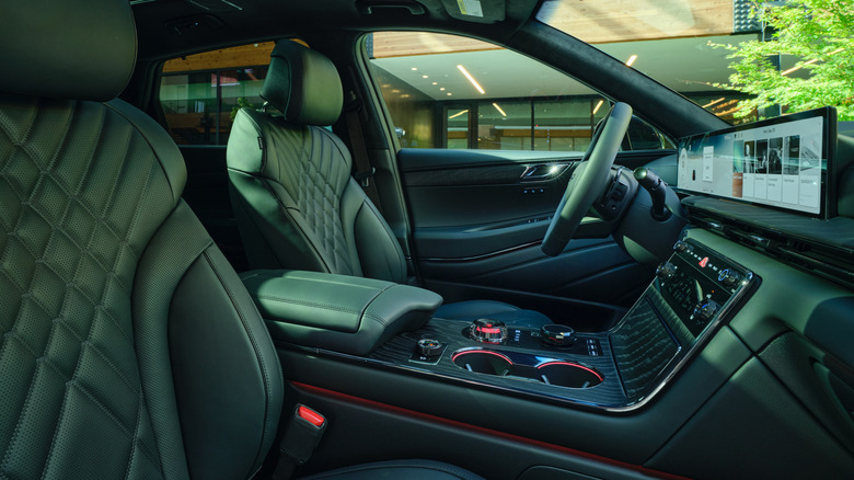 Interior of 2026 Genesis GV80, with vehicle parked in front of a contemporary office building