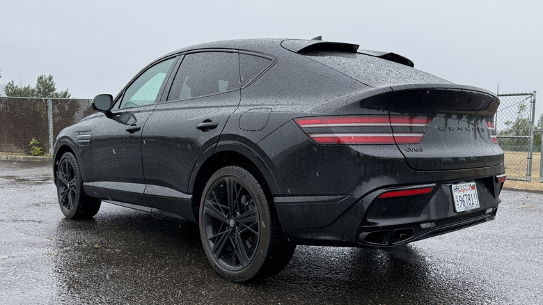 Rear quarter view of parked Genesis GV80 Coupe Prestige Black