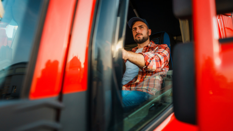 Trucker sitting in the driver's seat.