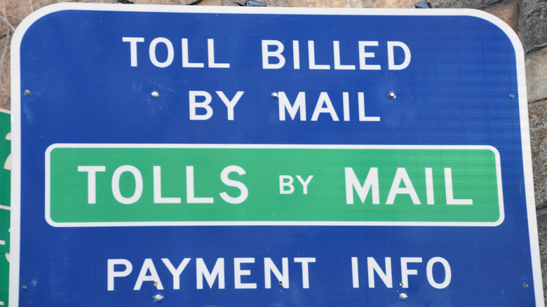 A toll by mail sign on the roadway