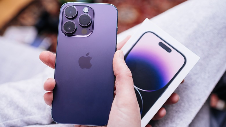 person holding iphone 14