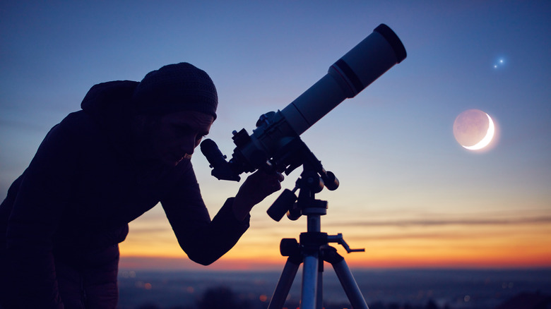 Observing the night sky with a telescope.