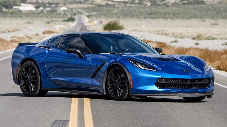 Side view of a C7 Chevrolet Corvette parked on a country road