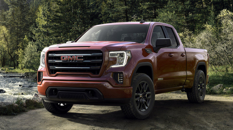 Red 2019 GMC Sierra Elevation Truck pariked near a river.