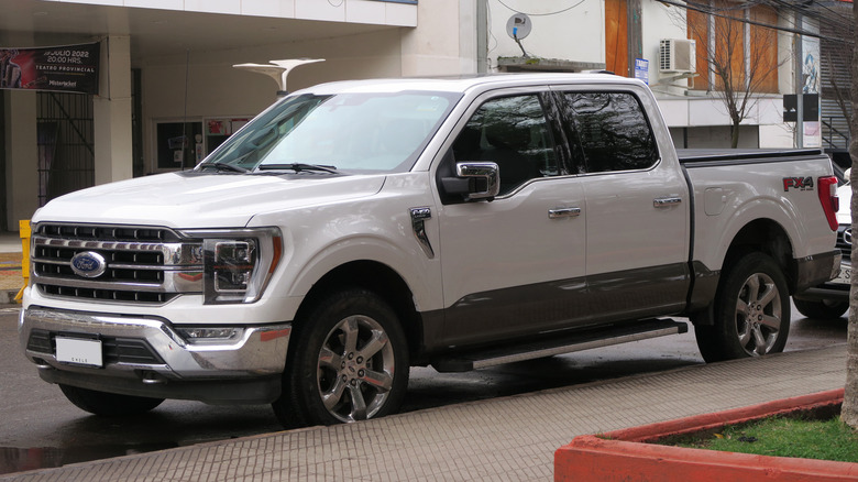 2022 Ford F-150 Lariat Luxury parked on a paved surface in front of a building