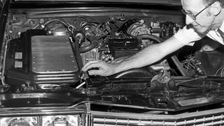 Coal-powered GM engine with engineer reaching over to show coal delivery system