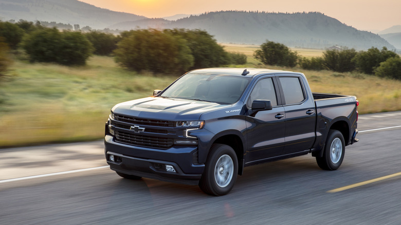 2021 Chevrolet Silverado driving on open road, front-left 3/4 view
