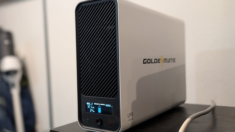 GOLDENMATE UPS Battery Backup and Surge Protector on table.