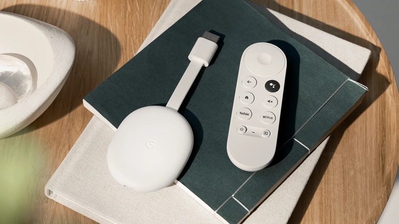 Chromecast with Google TV and remote on living room table with books