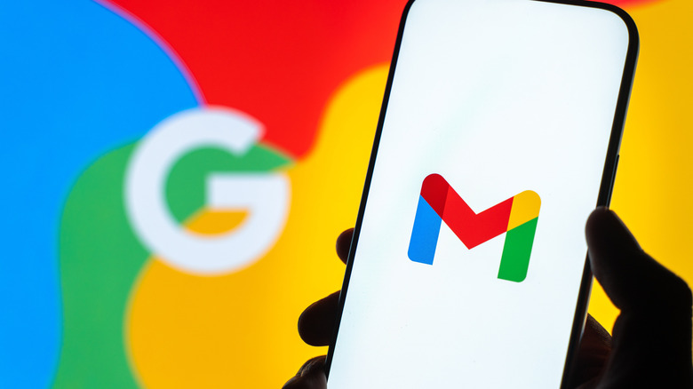 A smartphone showing the Gmail logo in front of Google imagery.