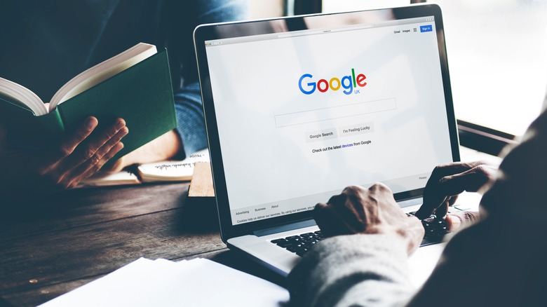 Person using google on laptop