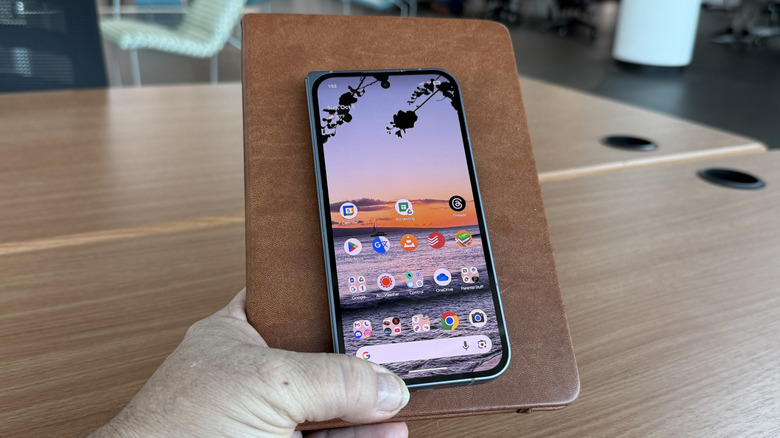 Google Pixel 10 Pro Fold on a book in a man's hand