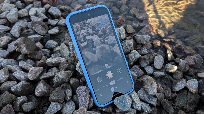 Google Pixel 8a on rocks by water