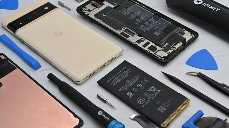 Google Pixels opened up with iFixit repair tools laid beside them.