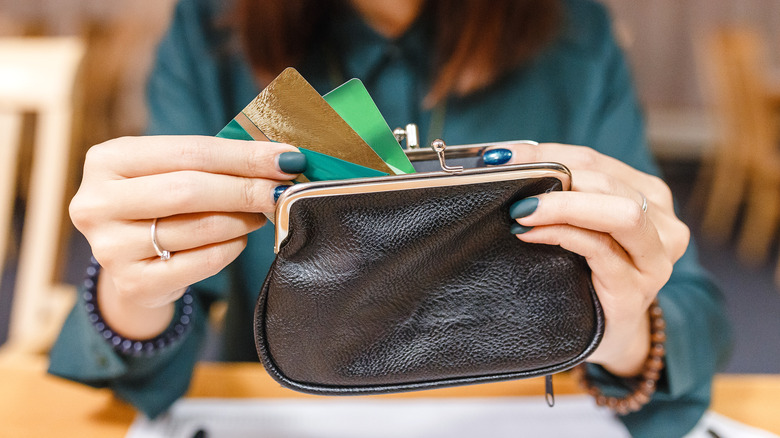 Person rummaging cards pocketbook