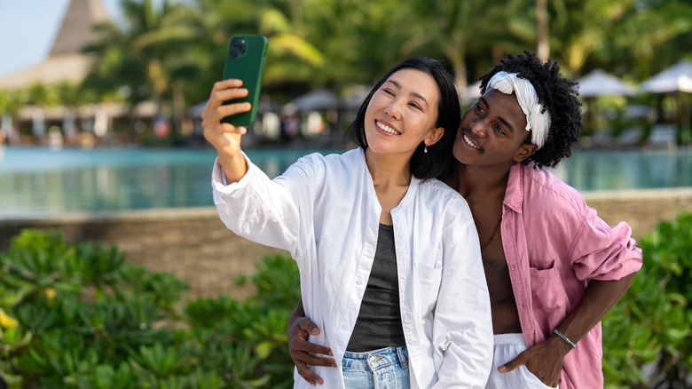 Couple take a selfie for social media while on holiday