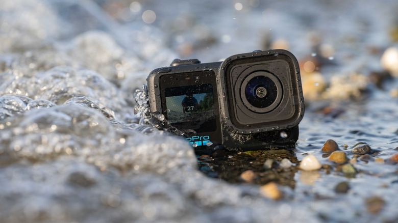The GoPro Mission 1 Pro being hit by a wave at the beach.