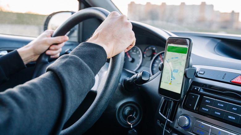Car driver using a smartphone navigation app