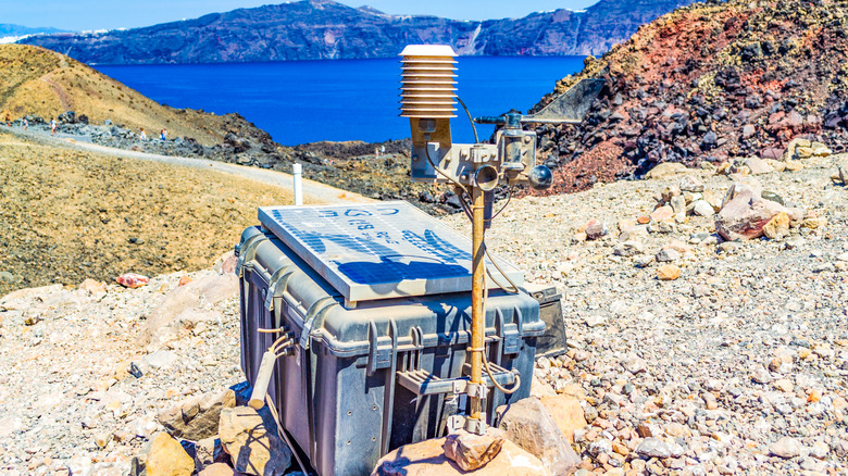 GPS monitoring equipment near a volcanic crater in Santorini, Greece