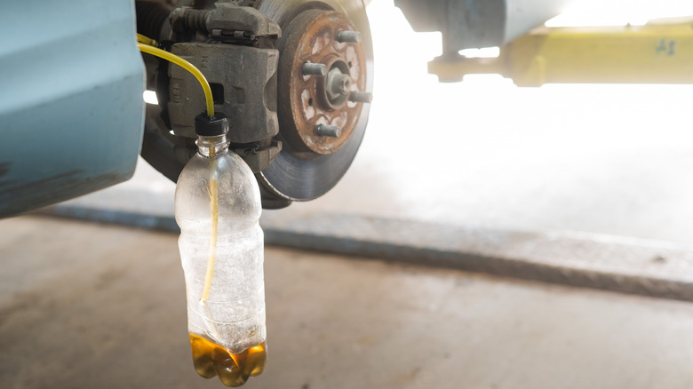 Brake fluid pumping into a plastic bottle