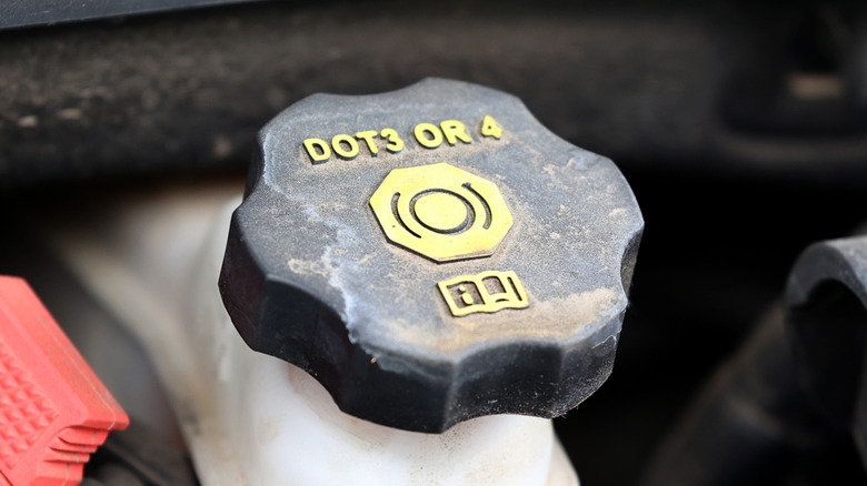Brake fluid reservoir showing DOT3 or DOT4 compatibility