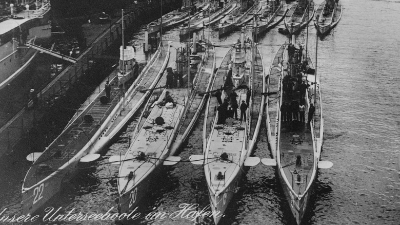 Row of World War I era submarines at dock
