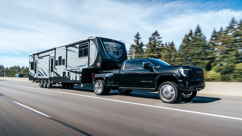 a truck pulling a large camper