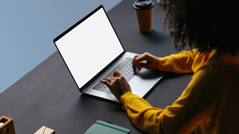 A girl typing on her laptop