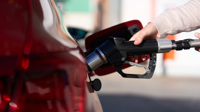 pumping gas at a gas station
