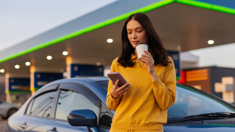 woman on phone in gas station