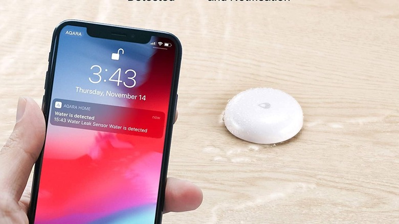 A phone being held in front of a smart sensor.