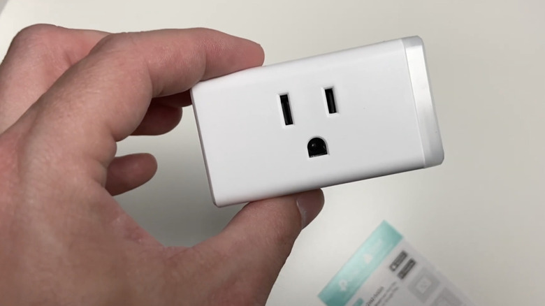 A smart plug plugged into an outlet.