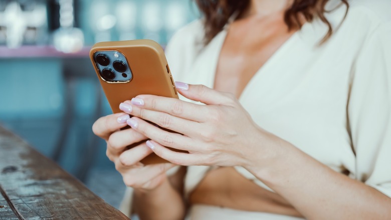 woman holding an iphone 