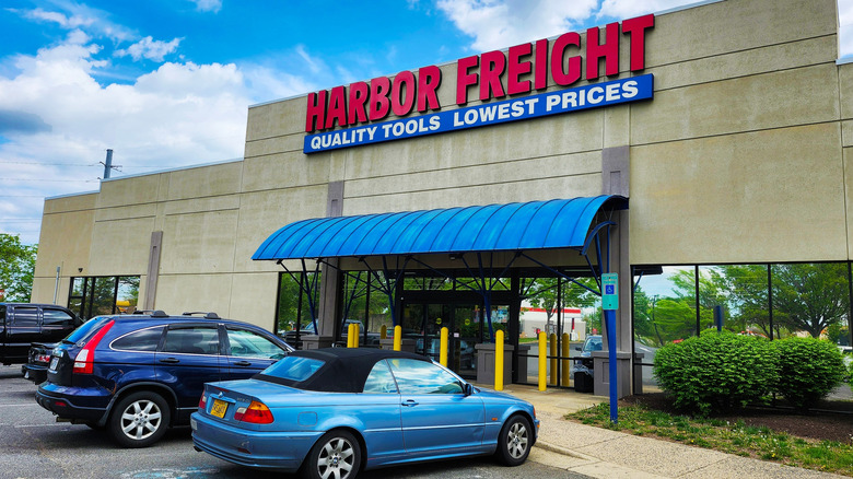 Cars parked in front of a Harbor Freight storefront.