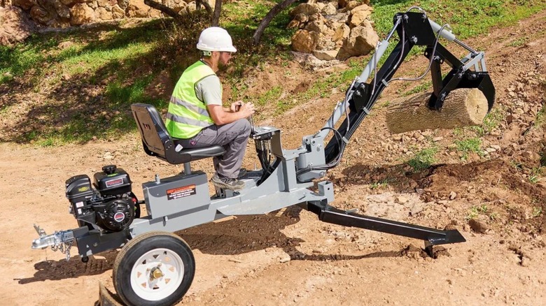 Person using a Harbor Freight Tools backhoe