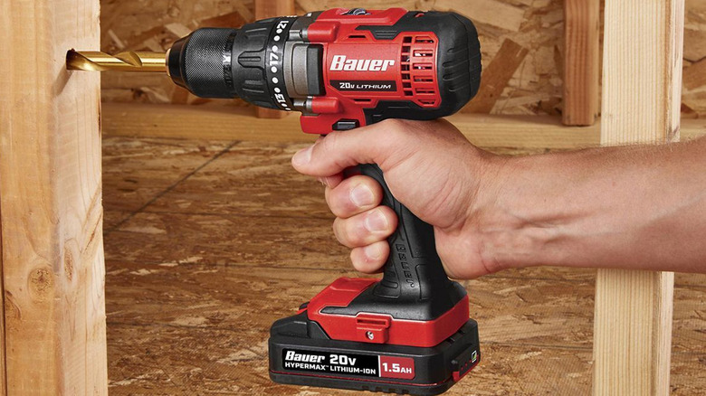 person using bauer cordless drill