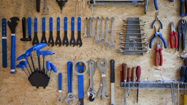 hand tools hanging on workshop wall