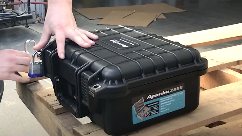Person pouring water over Apache storage case