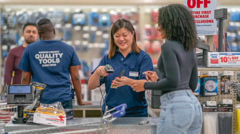 Harbor Freight employees assisting customers at check out