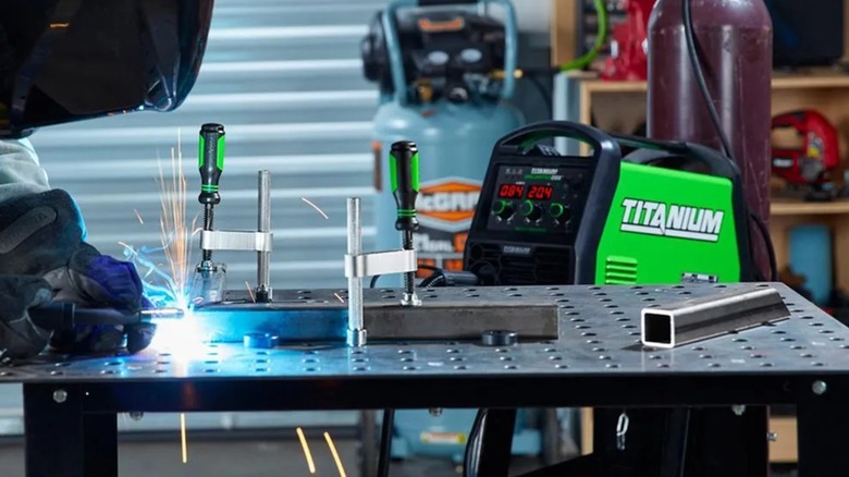A person working on a Titanium welding table from Harbor Freight.