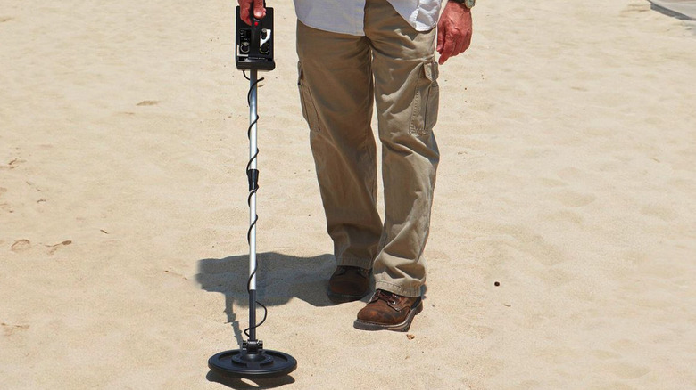Man using Harbor Freight 9 Function Metal Detector on the beach
