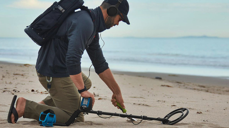 Man using Harbor Freight GORDON high-precision metal detector on the beach
