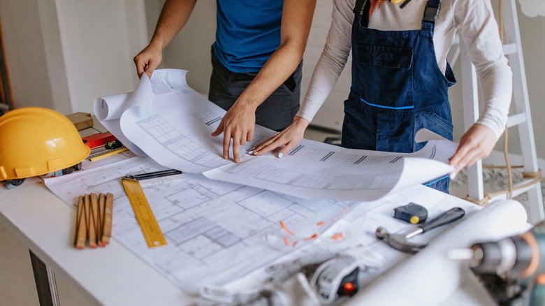 two people going over construction blueprints