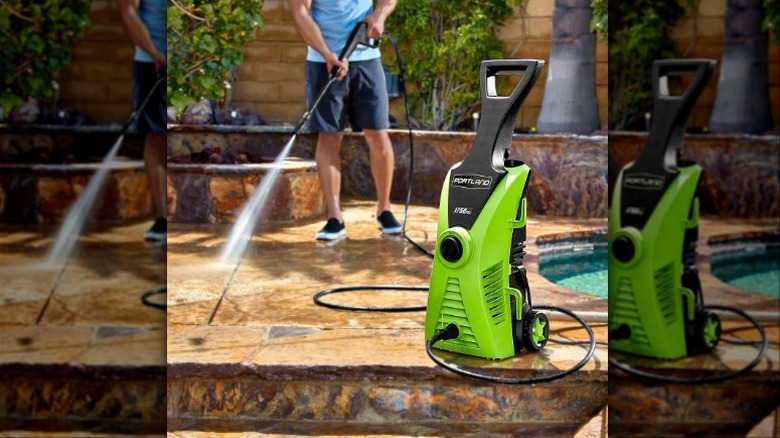 Man using pressure washer around a pool