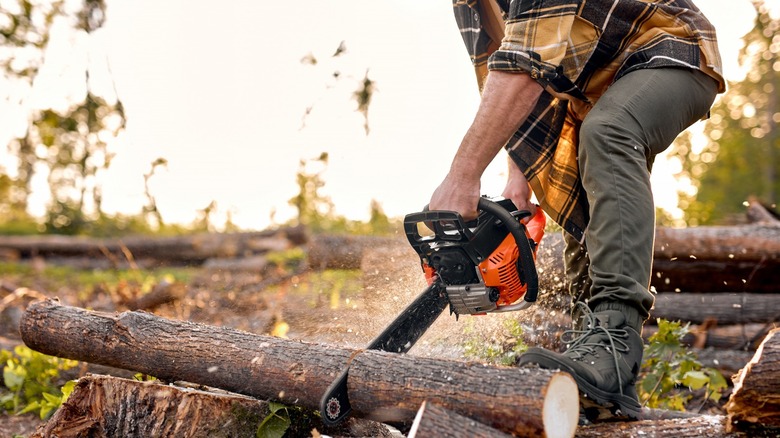 person using a chainsaw