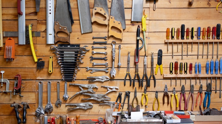 Tools hanging against a wooden wall