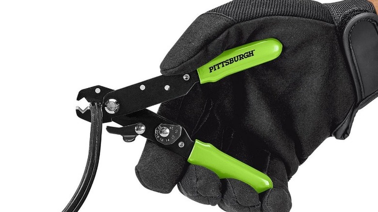 Person using Pittsburgh wire strippers on white background