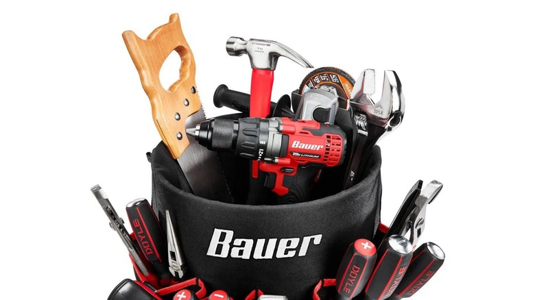 Close up of Bauer tool bag on 5 gallon bucket full of tools with white background