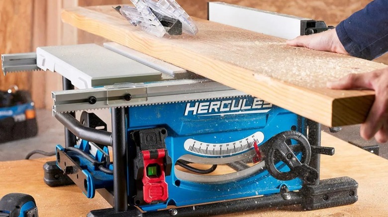 person cutting wood with Hercules 8-¼-inch Compact Table Saw